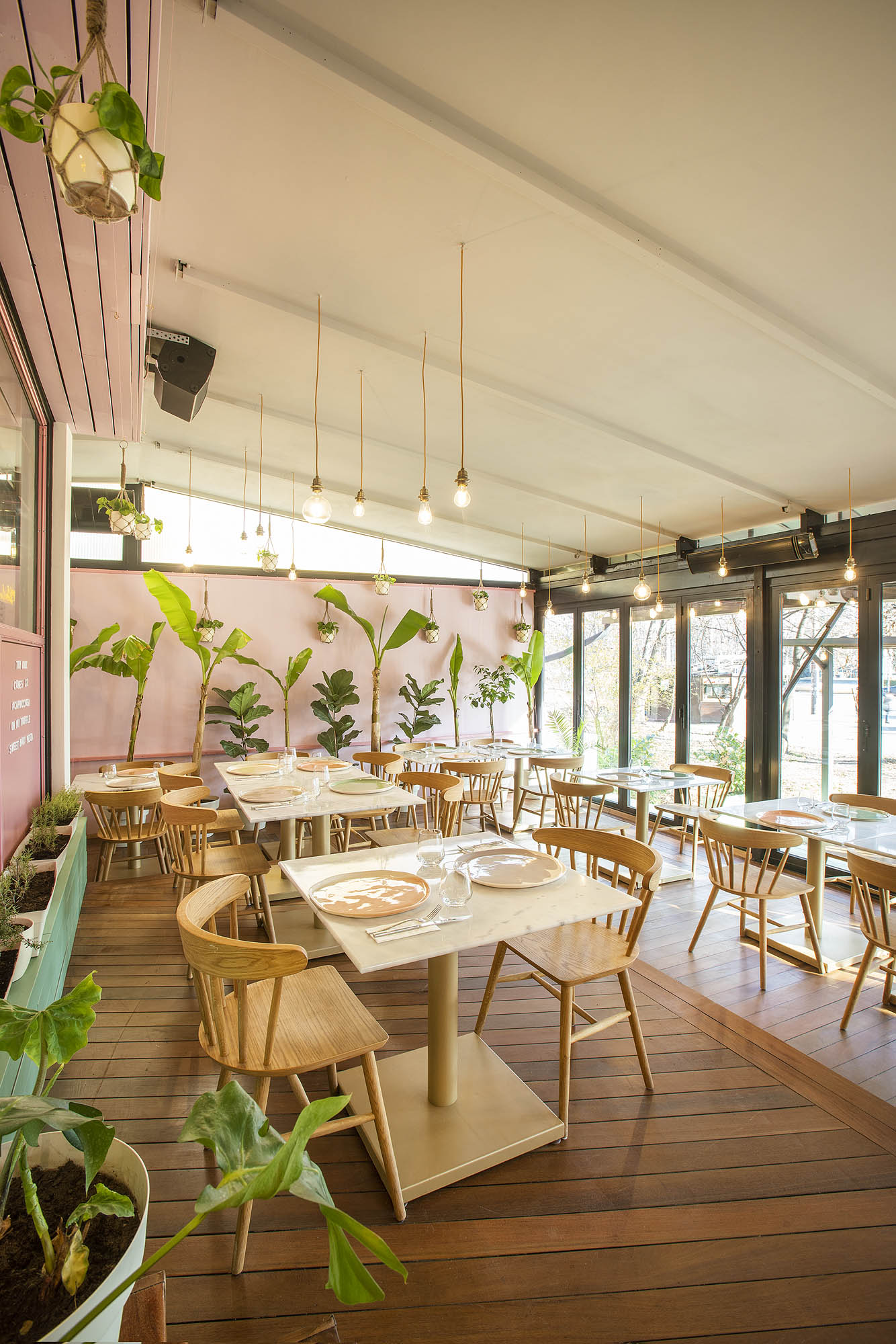 Restaurant interior with Pottery & Poetry porcelain plates on set tables.